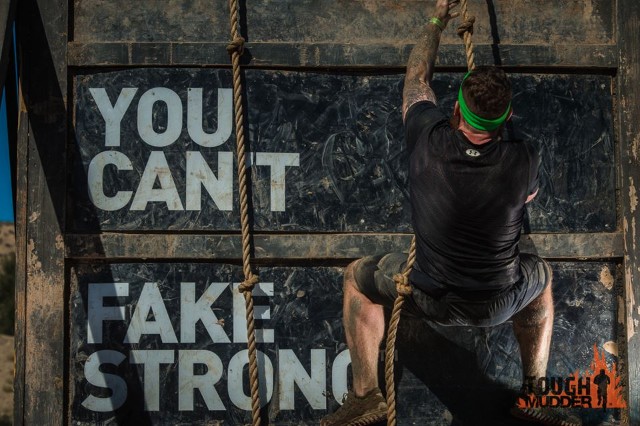 A mudder tackles an obstacle. 