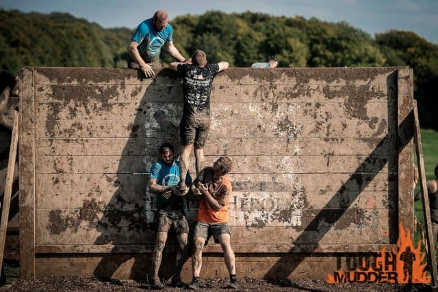 Mudders tackle a Hero Wall. 