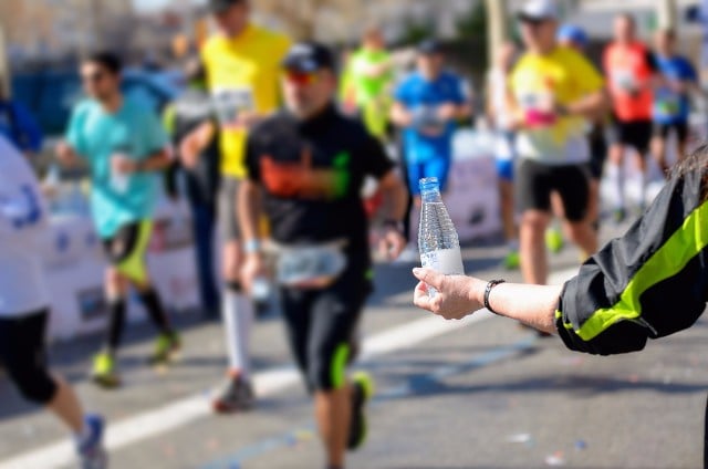 Bottles on water on offer at a marathon.