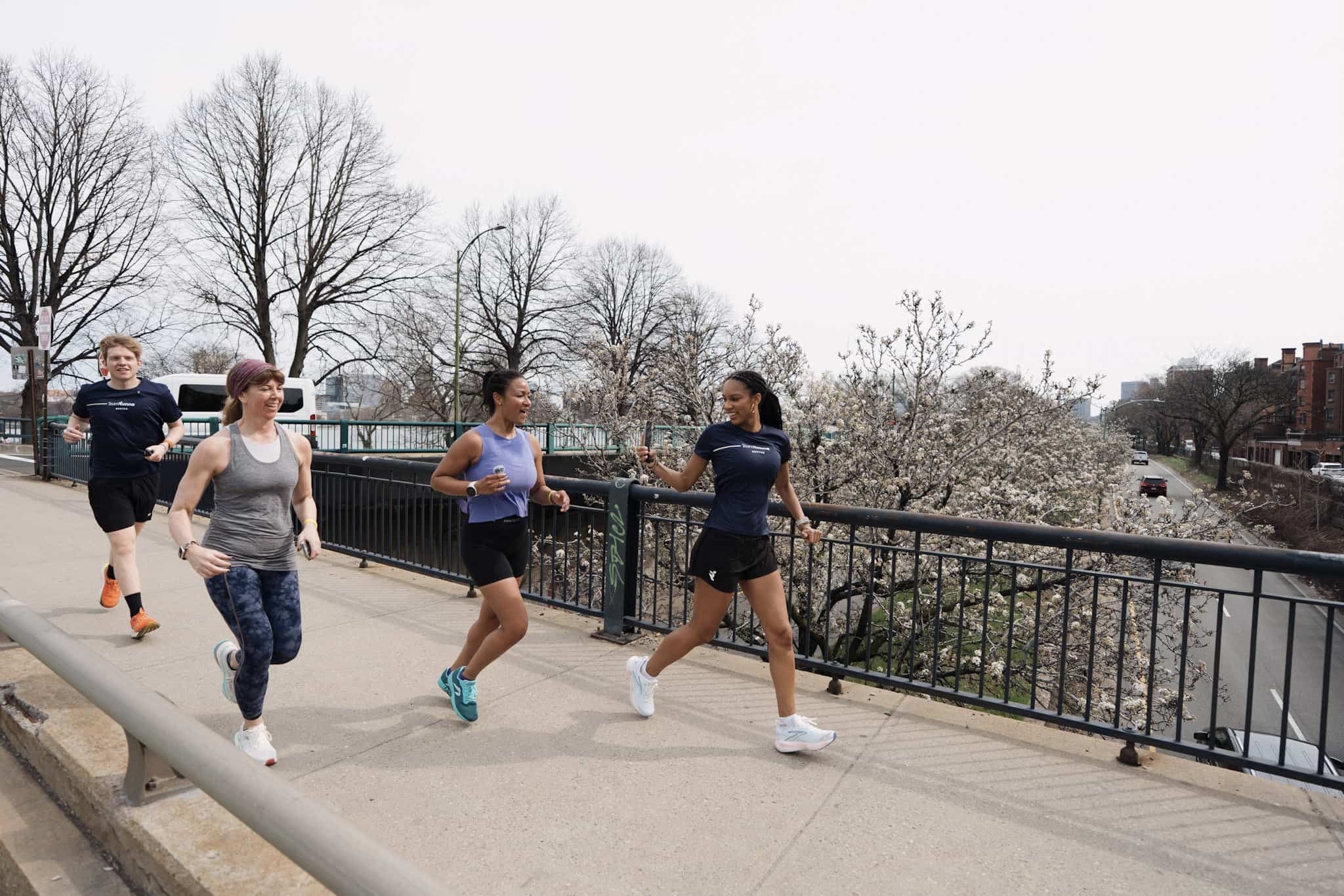 Four people running in a run club.