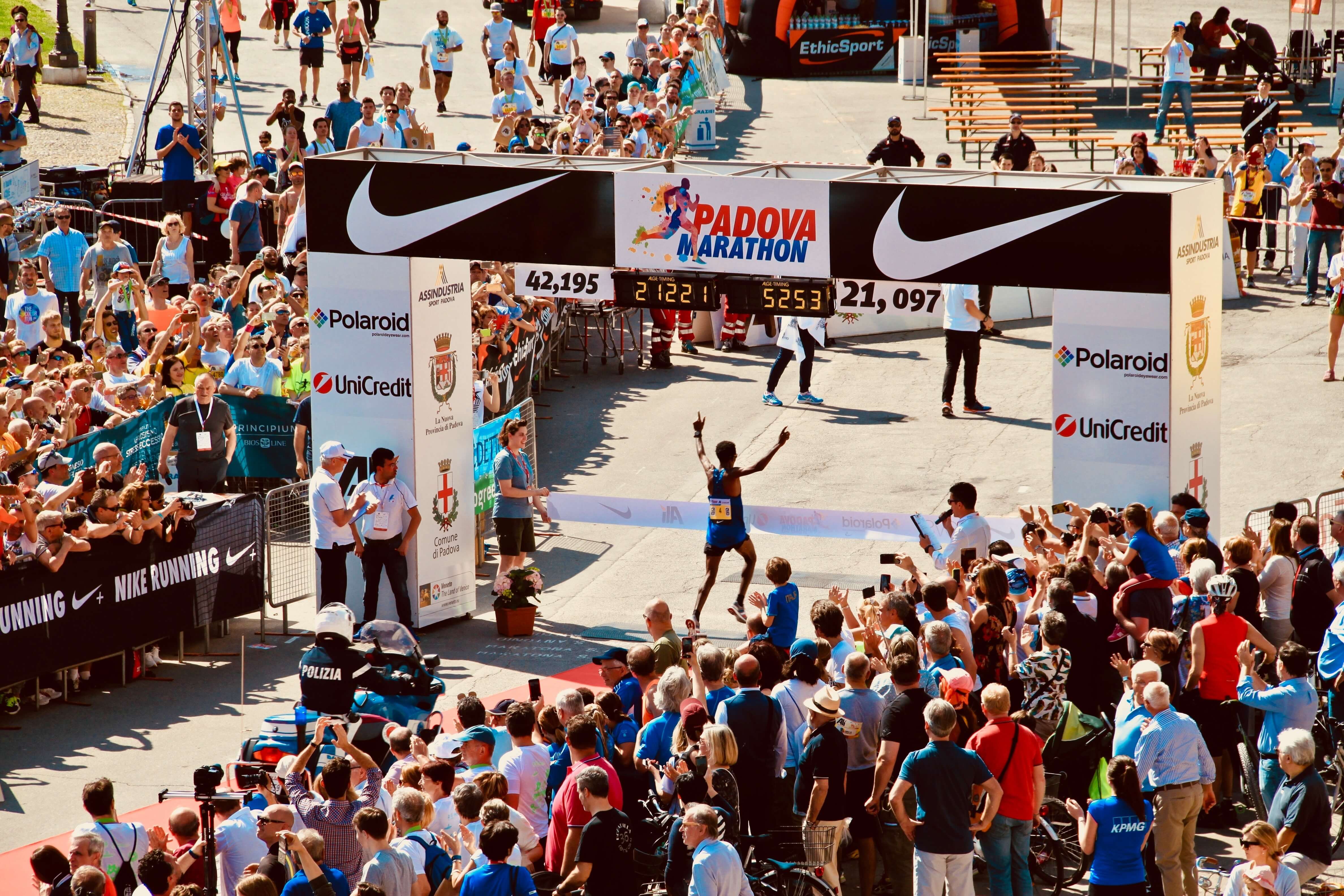 Marathon runner crossing the finish line at an official race.